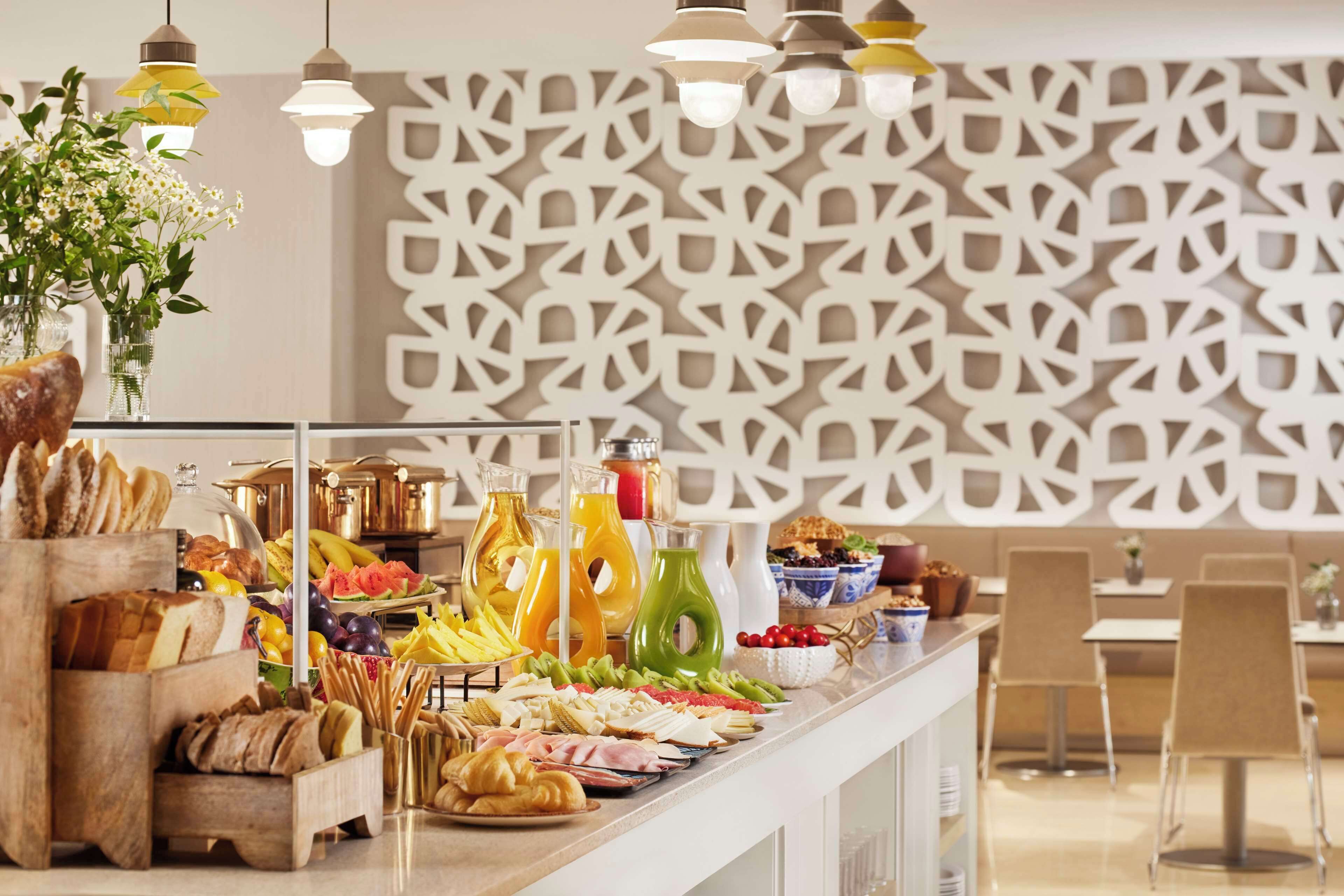 A buffet with various food items and beverages.