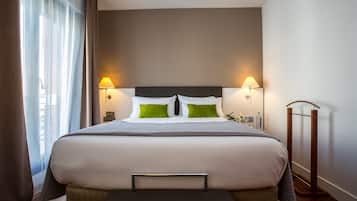 A neatly made bed with a headboard, two bedside lamps, and a bedside table with a lamp.
