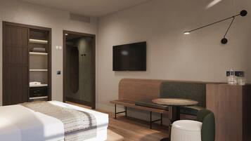 A modern hotel room with a bed, a seating area with a table, a TV, and a wardrobe.