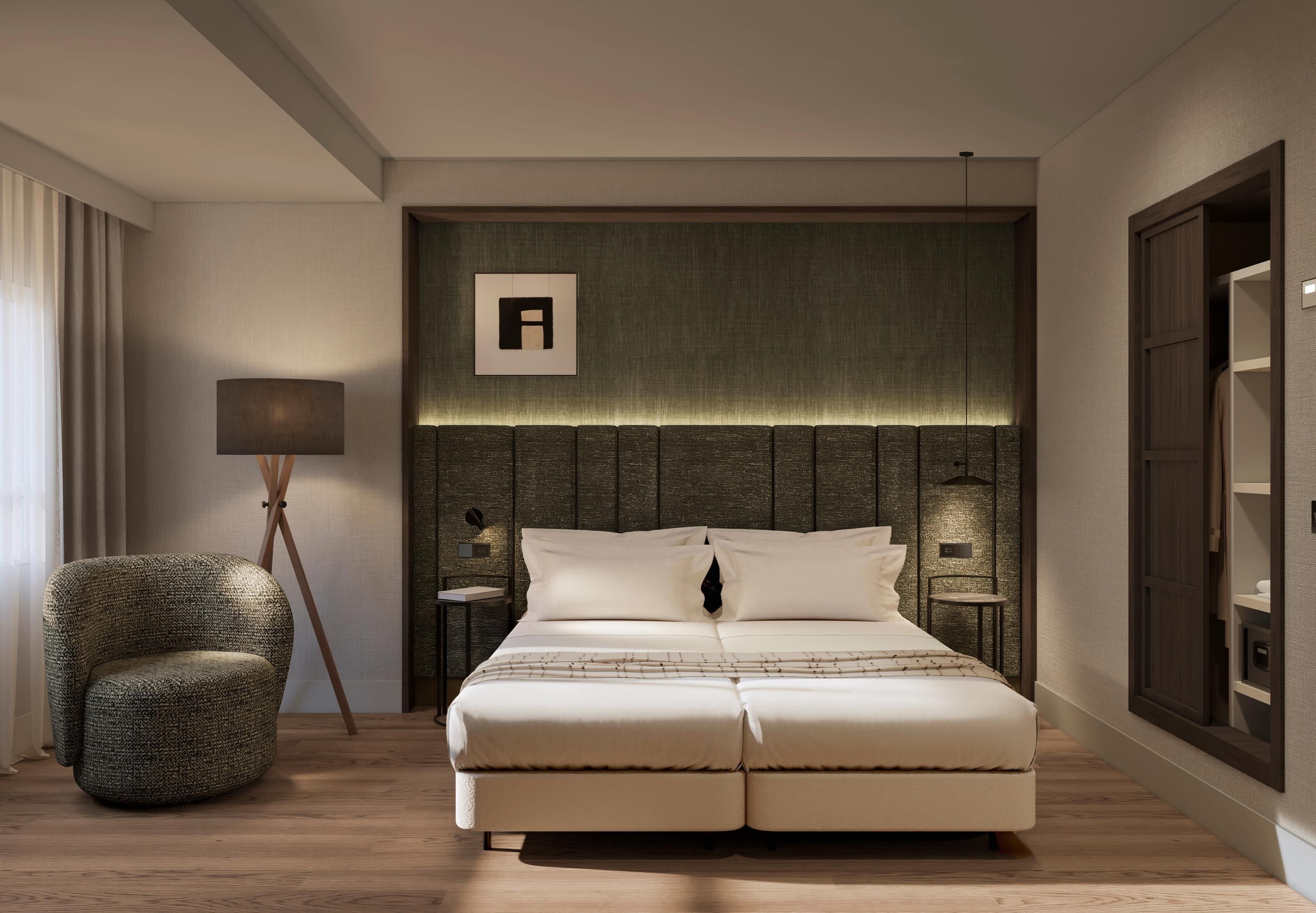 Une chambre d’hôtel moderne avec un grand lit, une table de chevet, une lampe et une chaise.