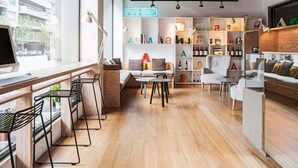 A modern interior with a bar area, seating, and a computer setup. - Mercure Barcelona Condor (Barcelona)