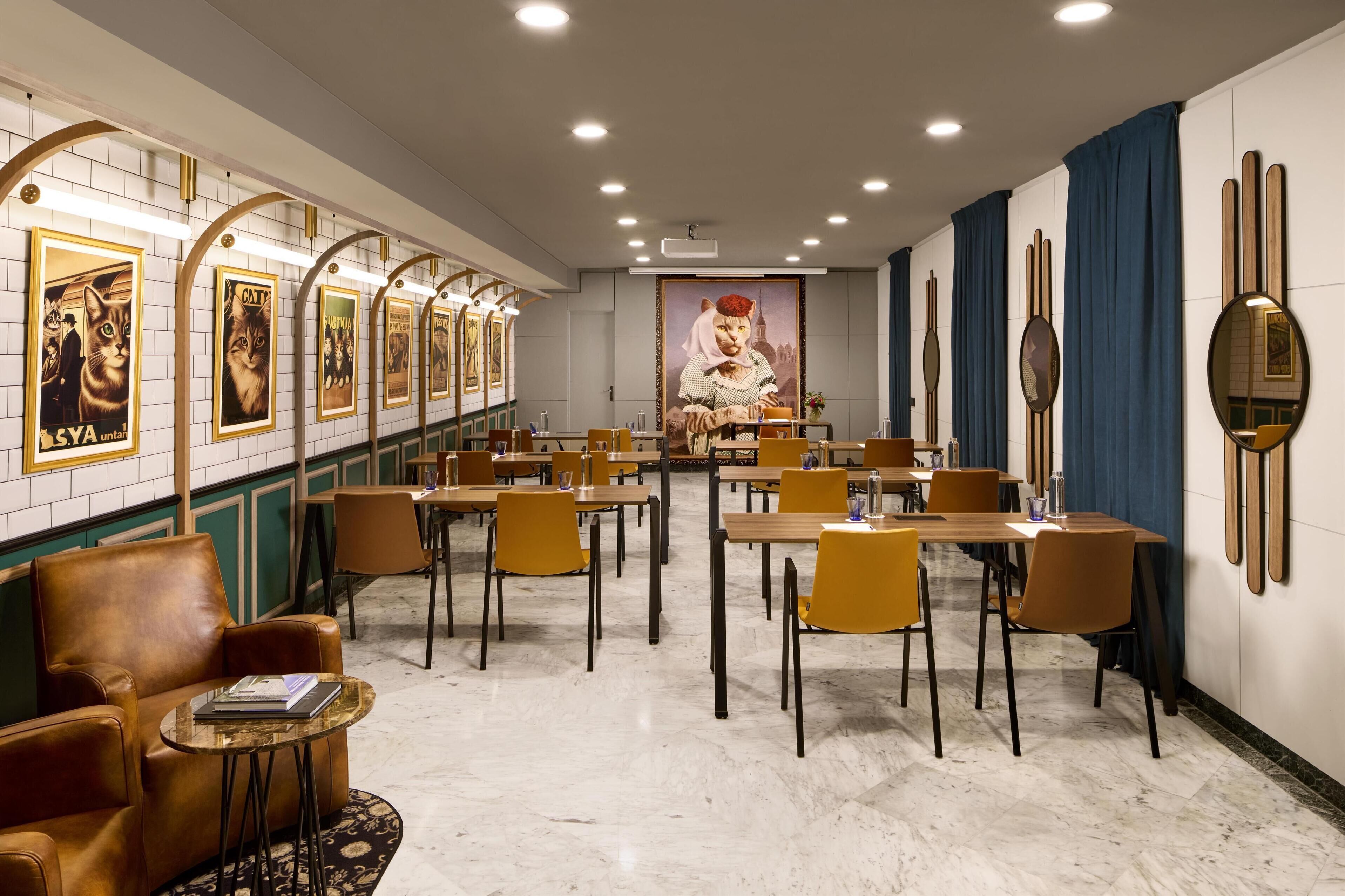 A restaurant with a long counter, multiple tables, and chairs.