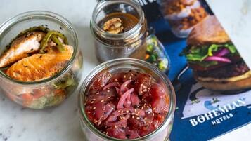 Two glass jars with food items, a menu, and a book.