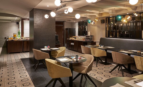 A modern restaurant with a breakfast buffet, seating area, and a bar.