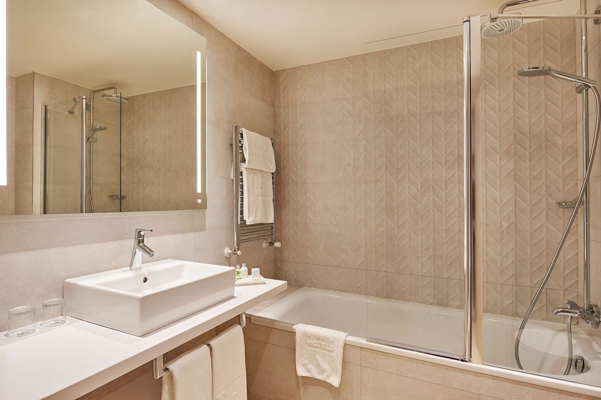 deep-soaking bathtub, rainfall showerhead, eco-friendly toiletries
