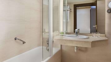 A modern bathroom with a glass-enclosed shower, a bathtub, and a vanity with a sink and mirror.