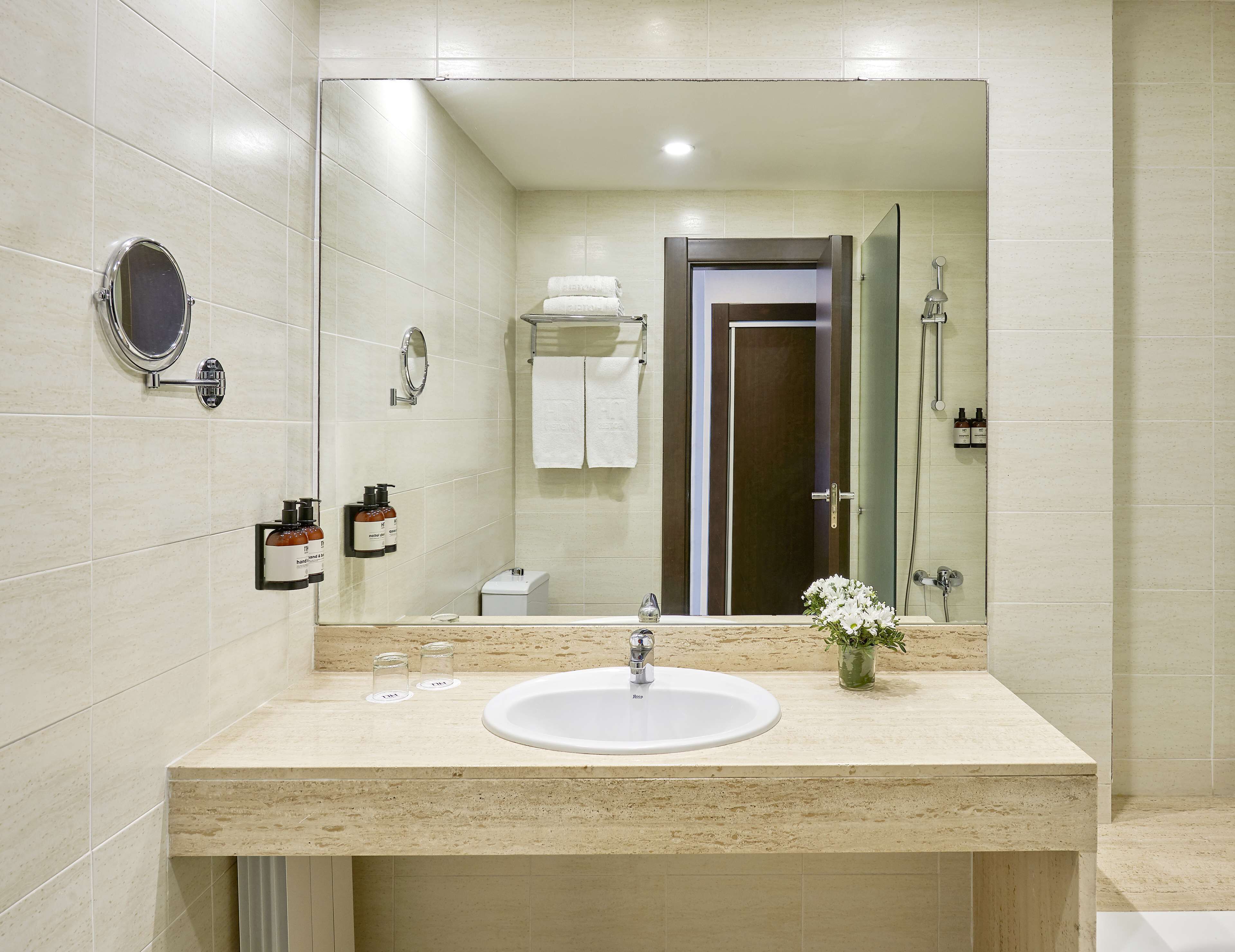 designer toiletries, hair dryer, bidet, towels