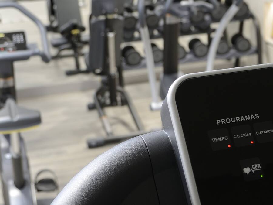 A gym equipment control panel with program settings and a digital display.