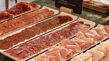 A variety of cured meats displayed on trays.