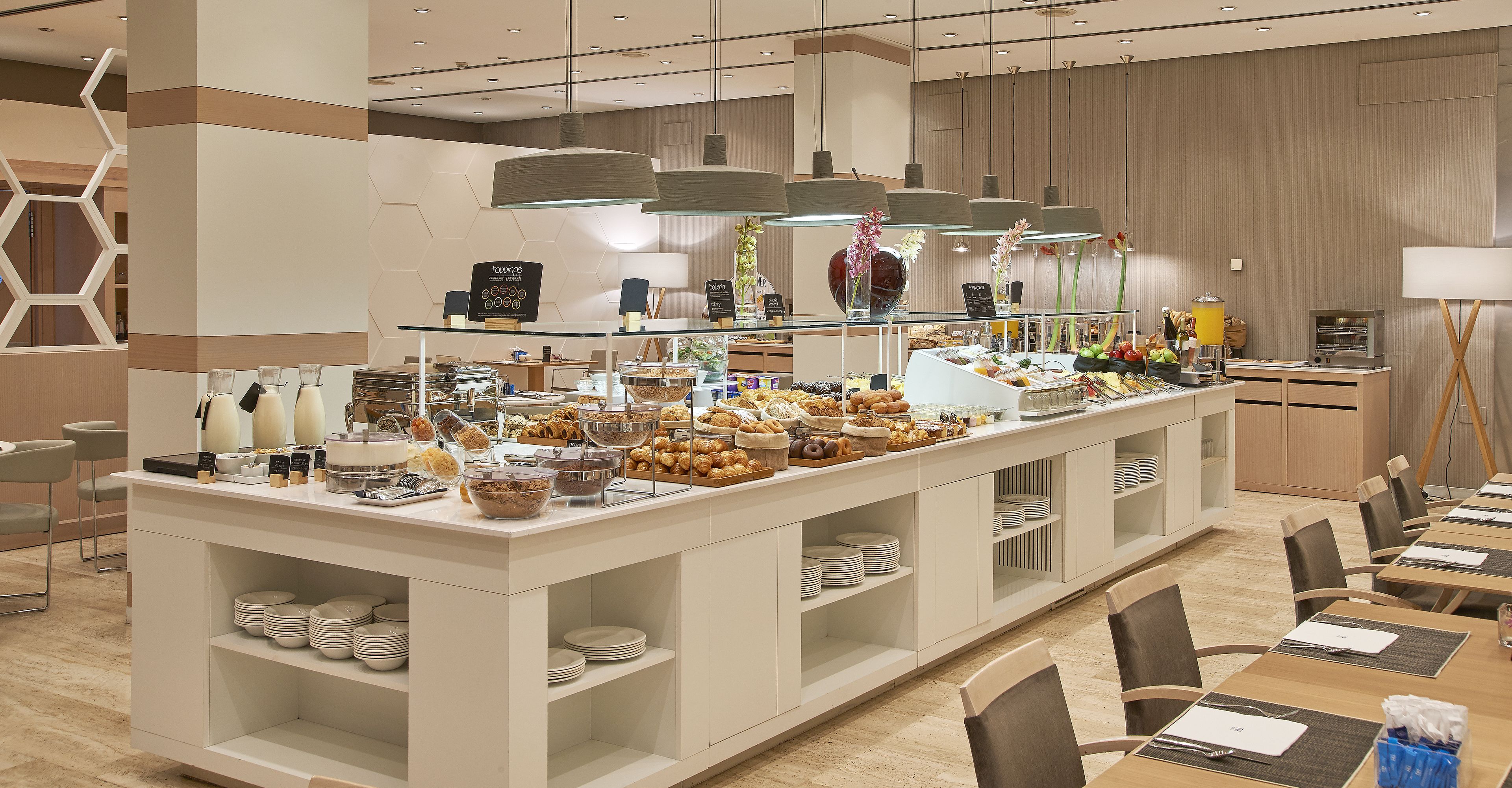 A buffet setup with various food items and a selection of beverages.