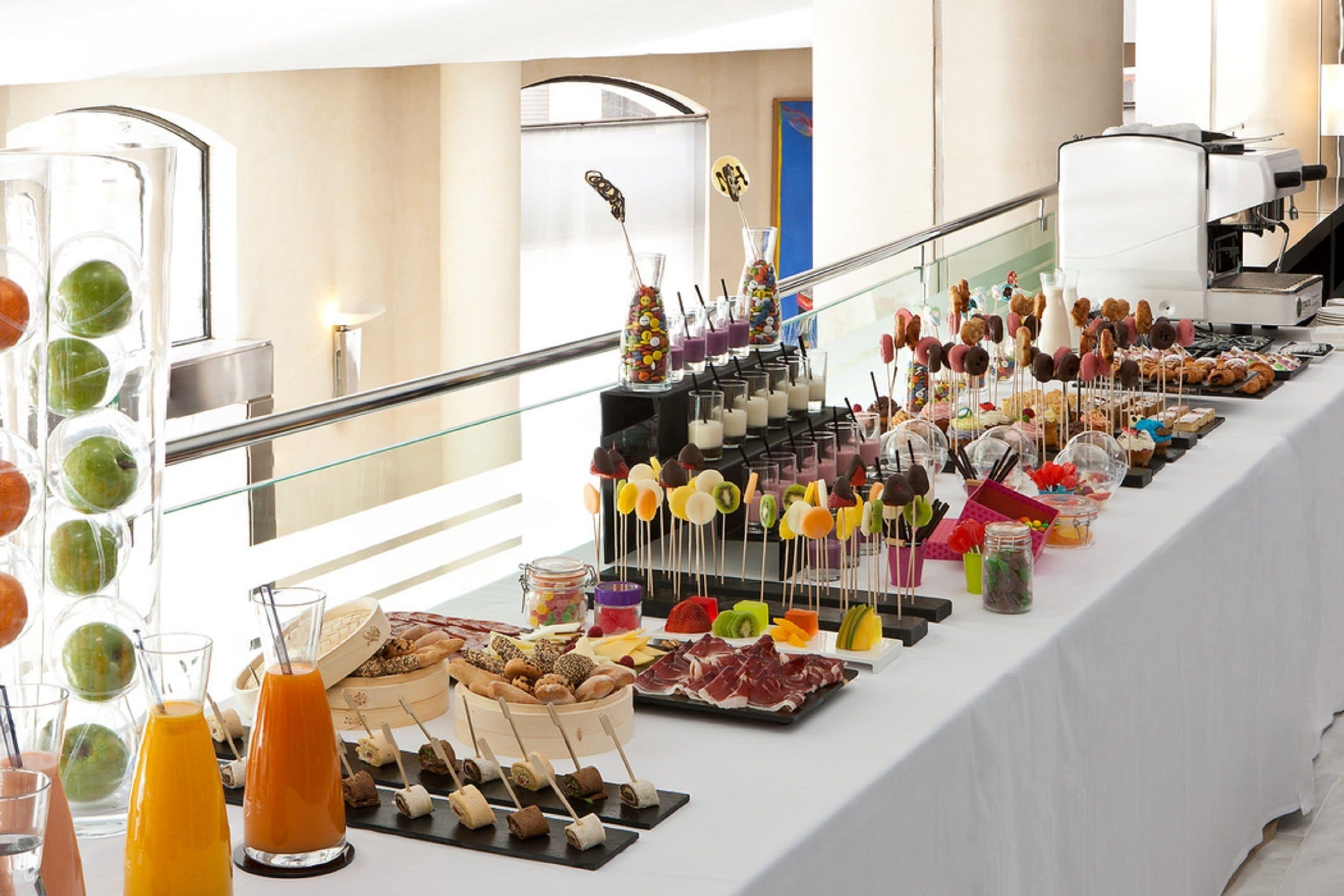 A buffet with various food items and drinks.