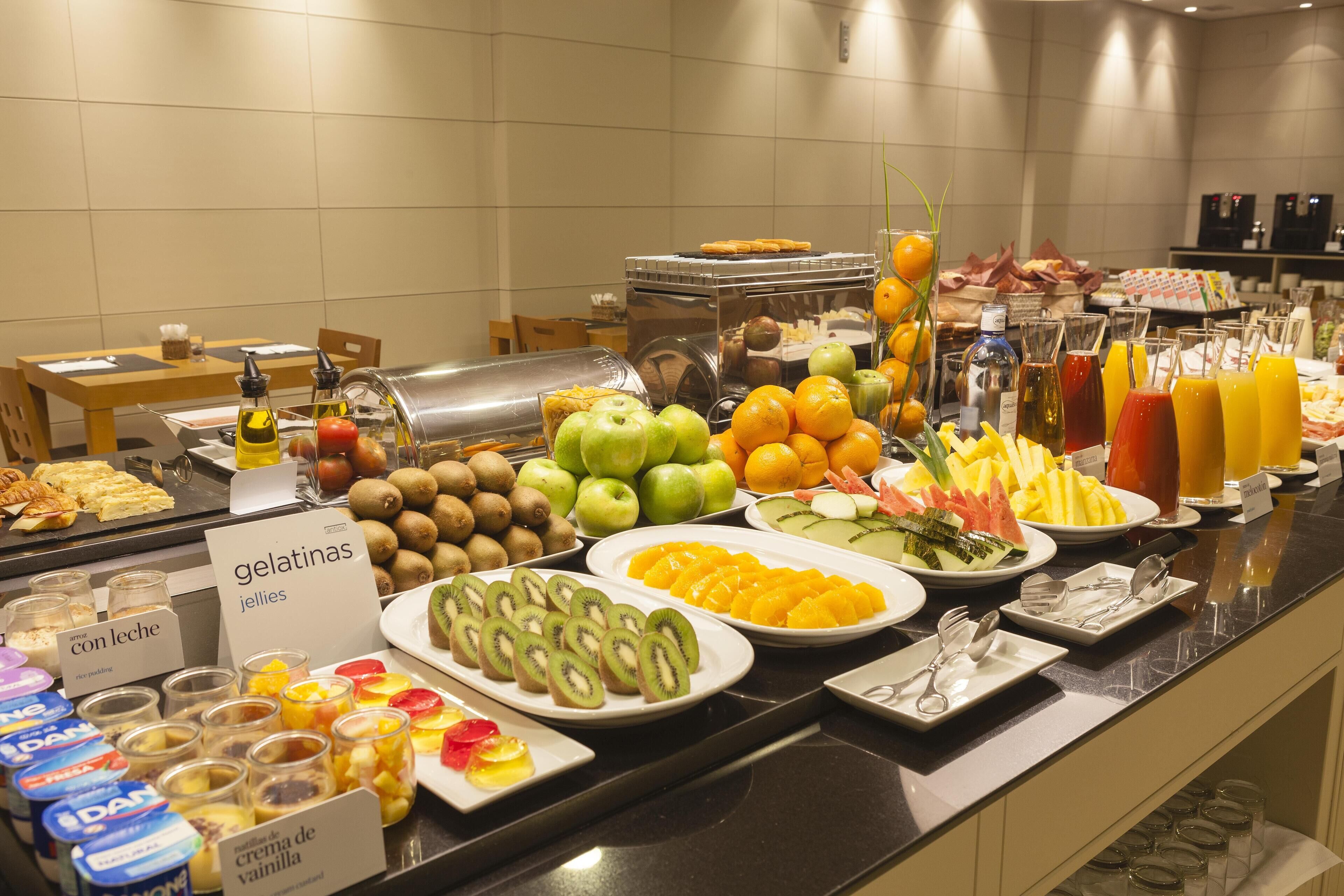 A buffet with various food items including fruits, vegetables, and dairy products.