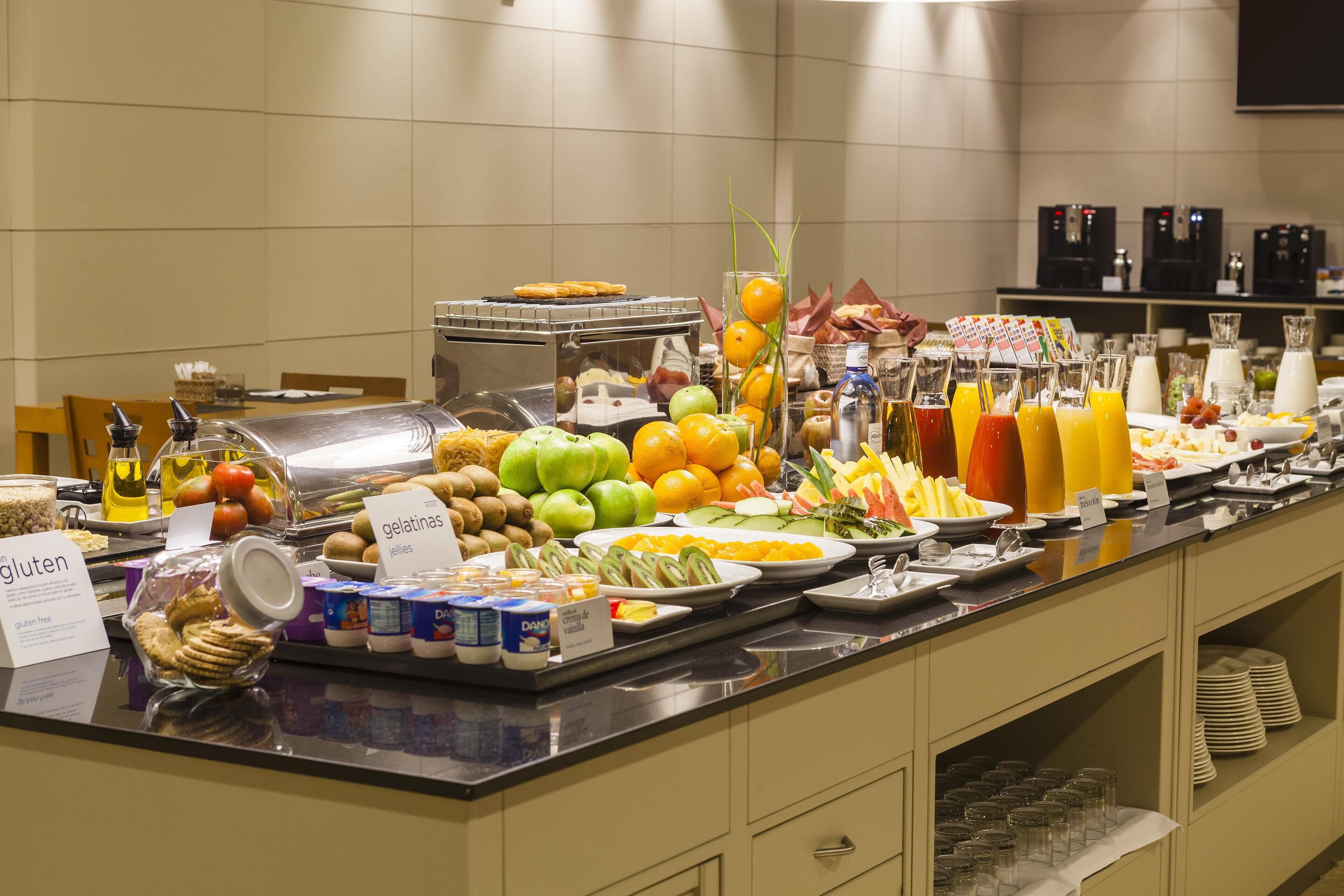 A buffet with various food items and beverages.