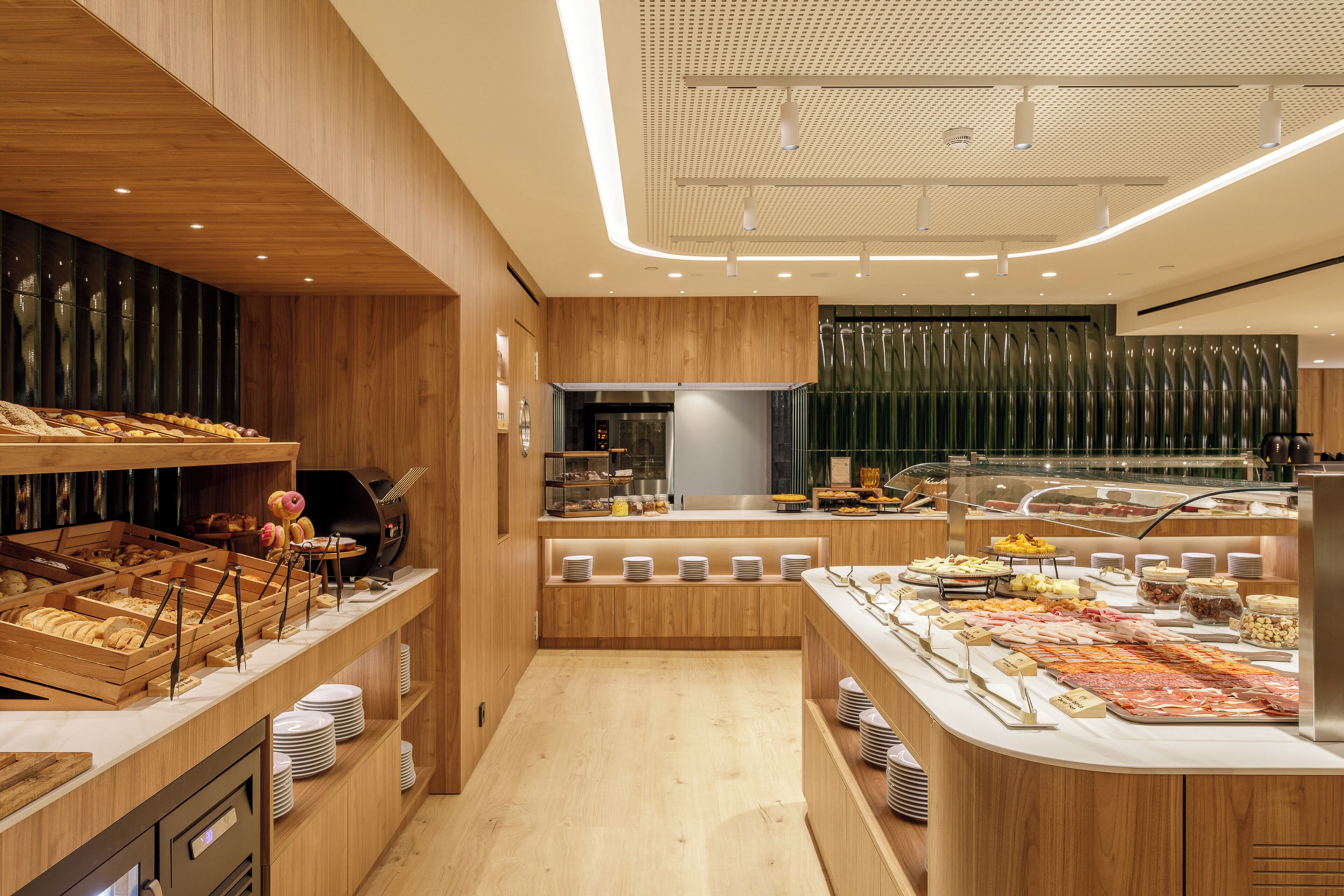 A buffet area with wooden cabinetry and a variety of food items.