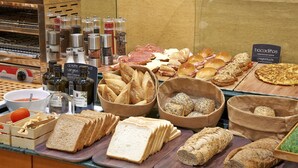 A variety of breads and pastries displayed in a bakery counter.