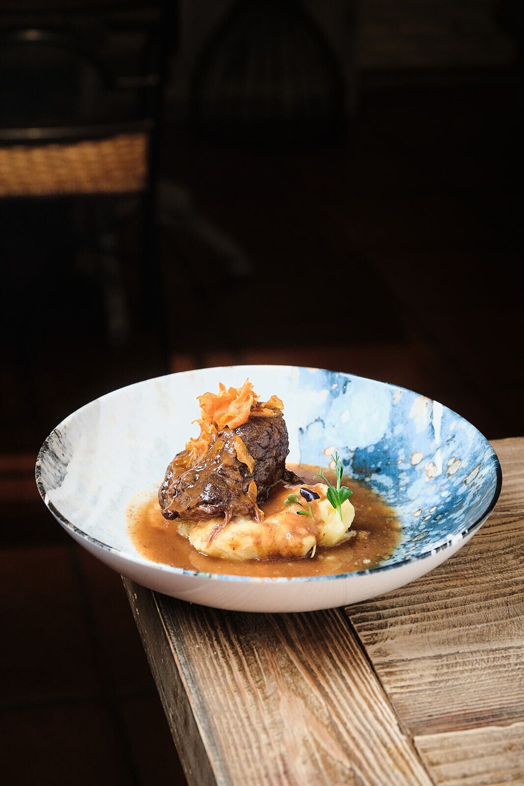 A plate of food on a wooden table.