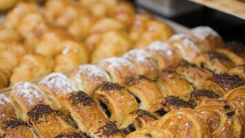 A variety of pastries displayed on trays.