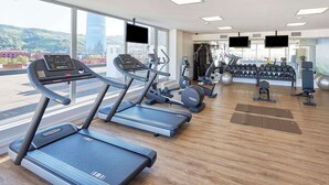 A modern gym with treadmills, weight machines, and exercise balls. - NH Collection Villa de Bilbao (Bilbao)
