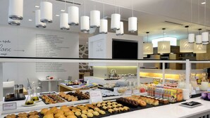 A breakfast buffet with various pastries, sandwiches, and beverages. - NH Collection Villa de Bilbao (Bilbao)