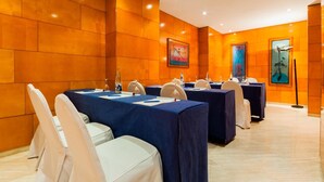 A conference room with tables set for meetings, equipped with microphones and nameplates. - Hotel Villacarlos (Valencia)
