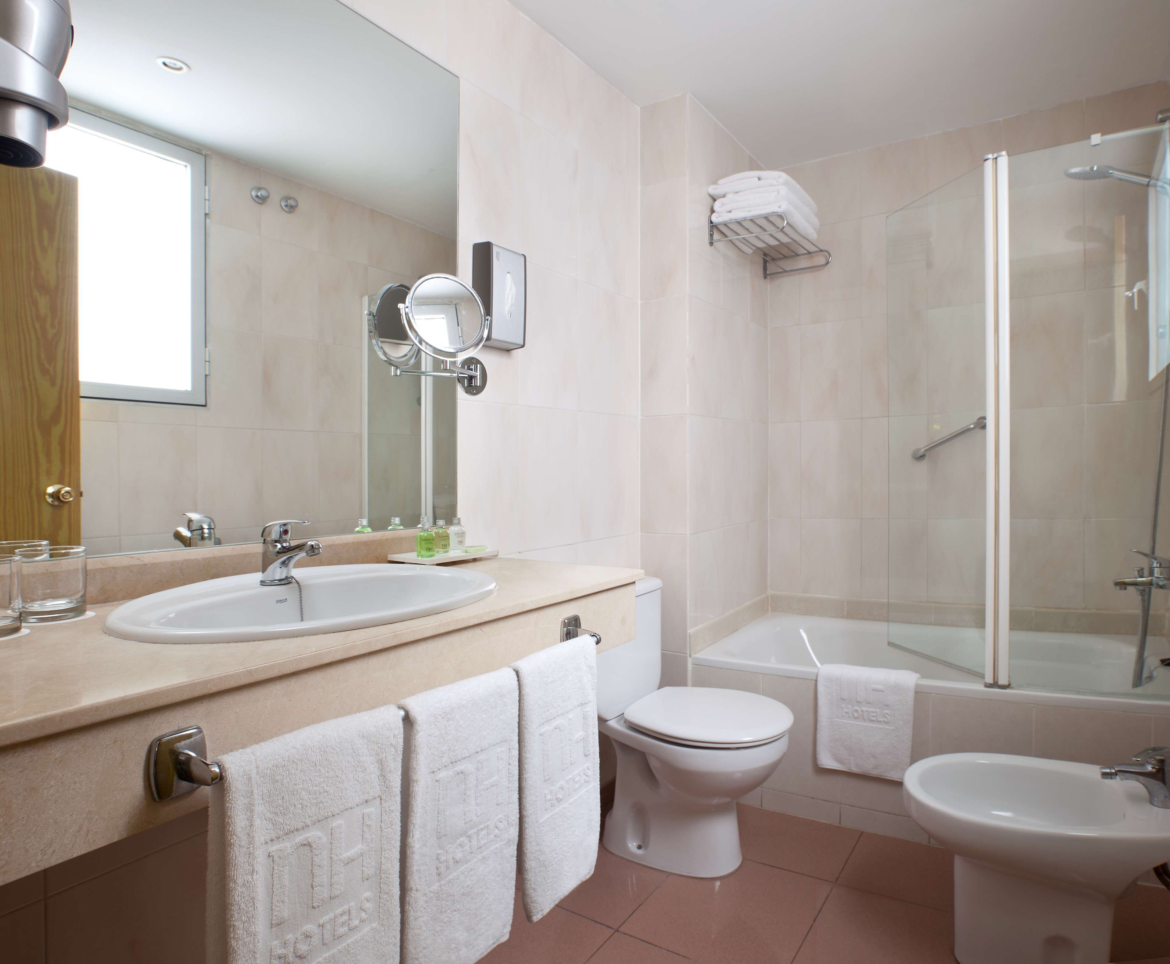 bathtub, eco-friendly toiletries, hair dryer, bidet