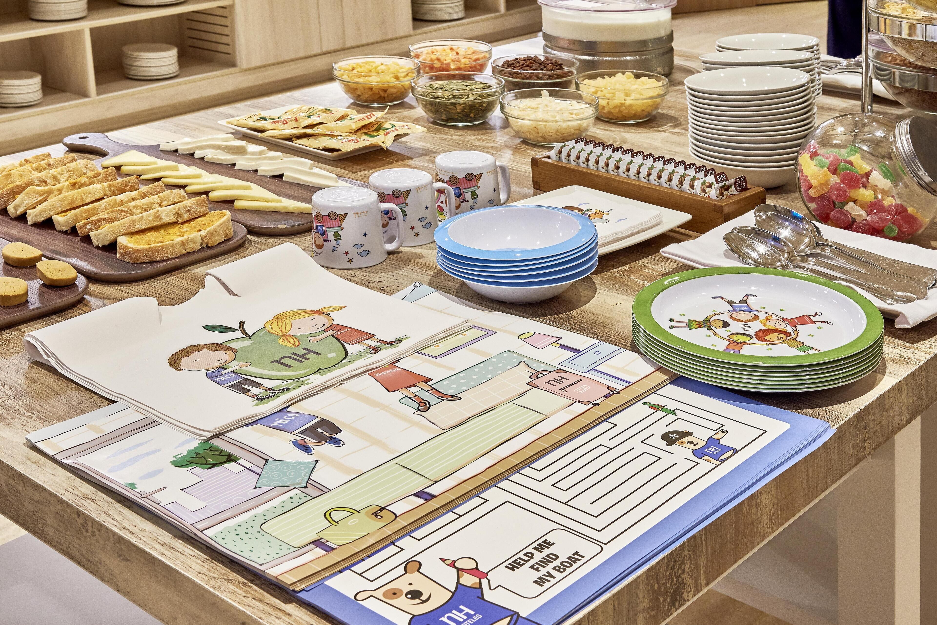 A buffet table with various food items and plates.