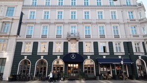 A historic building with a classic facade, featuring multiple windows and a prominent entrance with a sign. - Hotel Alexandra (Copenhagen)