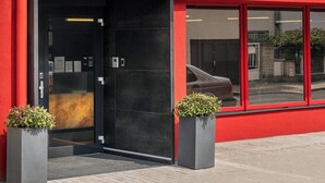 The exterior of Hotel Aida with a modern facade, large windows, and a prominent entrance. - Aida Hotel (Prague)