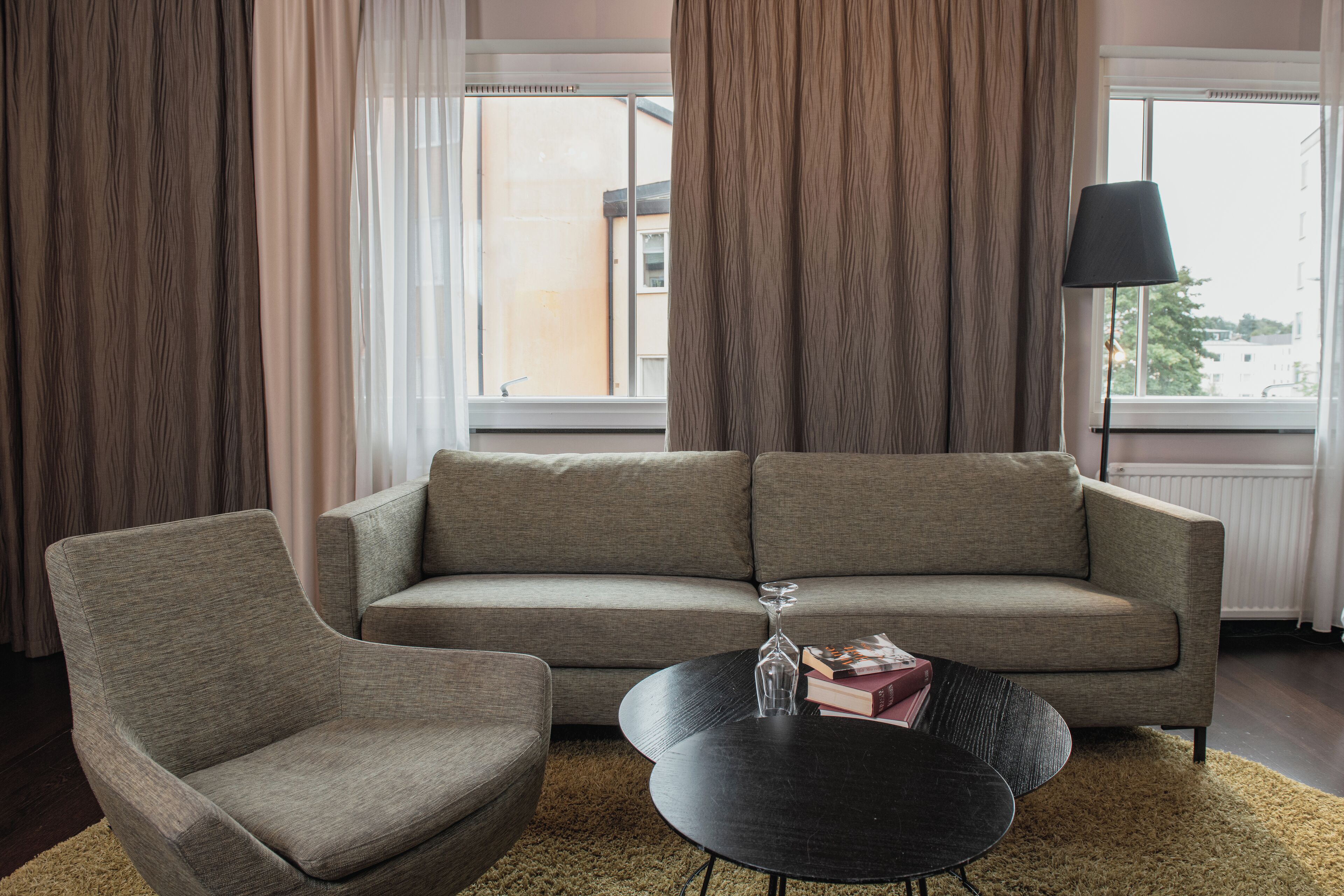 A living room with a sofa, armchair, and coffee table.