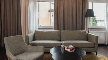 A living room with a sofa, armchair, and coffee table.