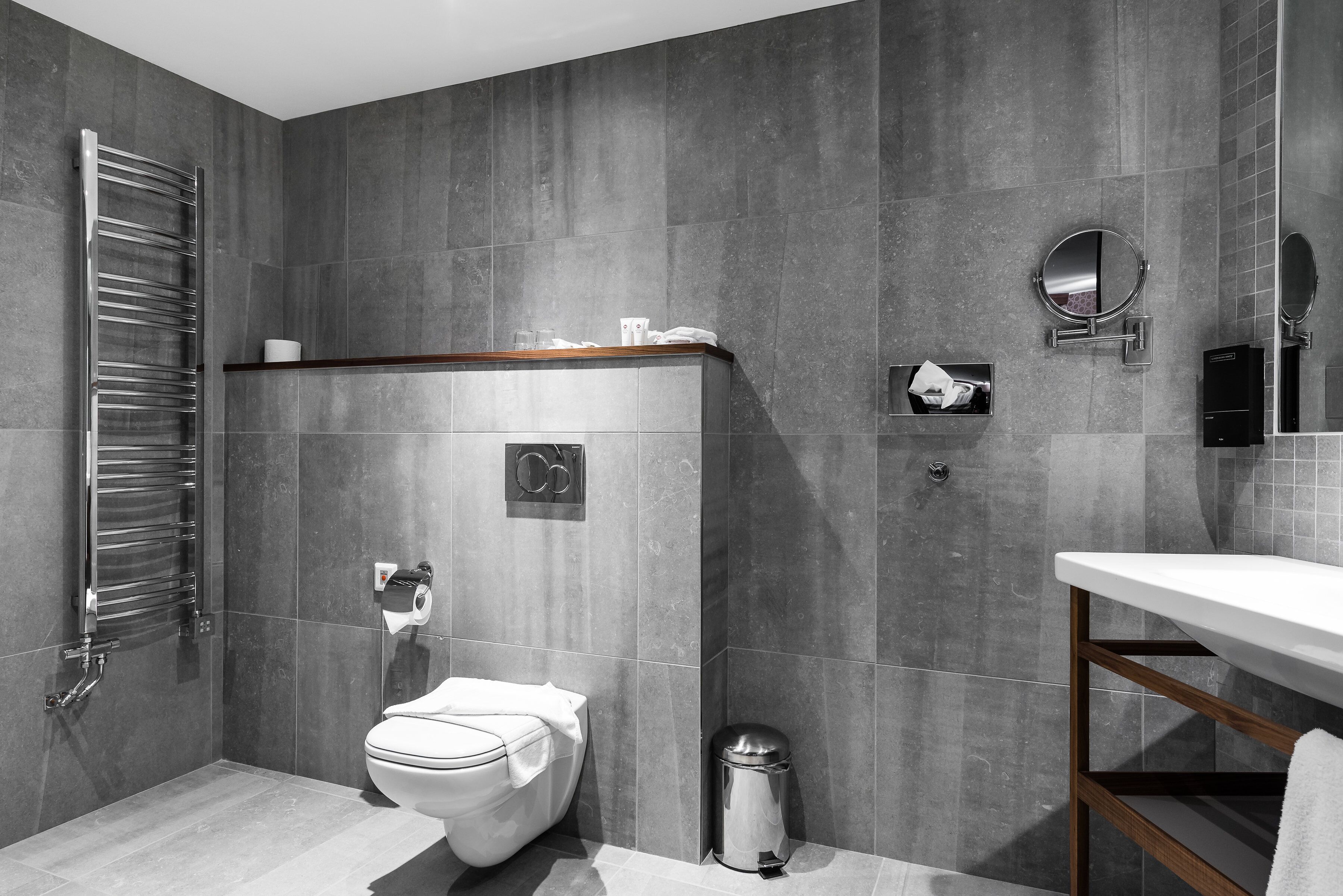 A modern bathroom with a toilet, bidet, and a sink.
