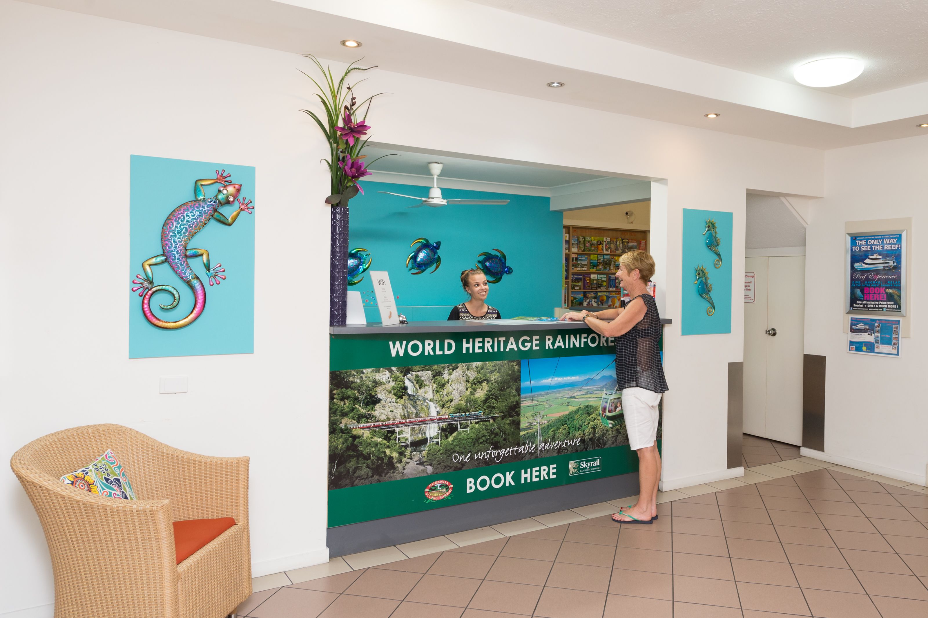 A reception desk with a sign for the World Heritage Rainforest.