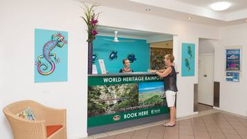 A reception desk with a sign for the World Heritage Rainforest.