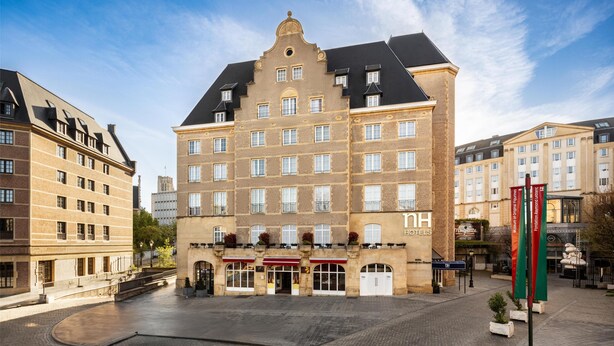 Un hôtel historique doté d’une cour intérieure, de plusieurs étages et d’un style architectural européen classique.