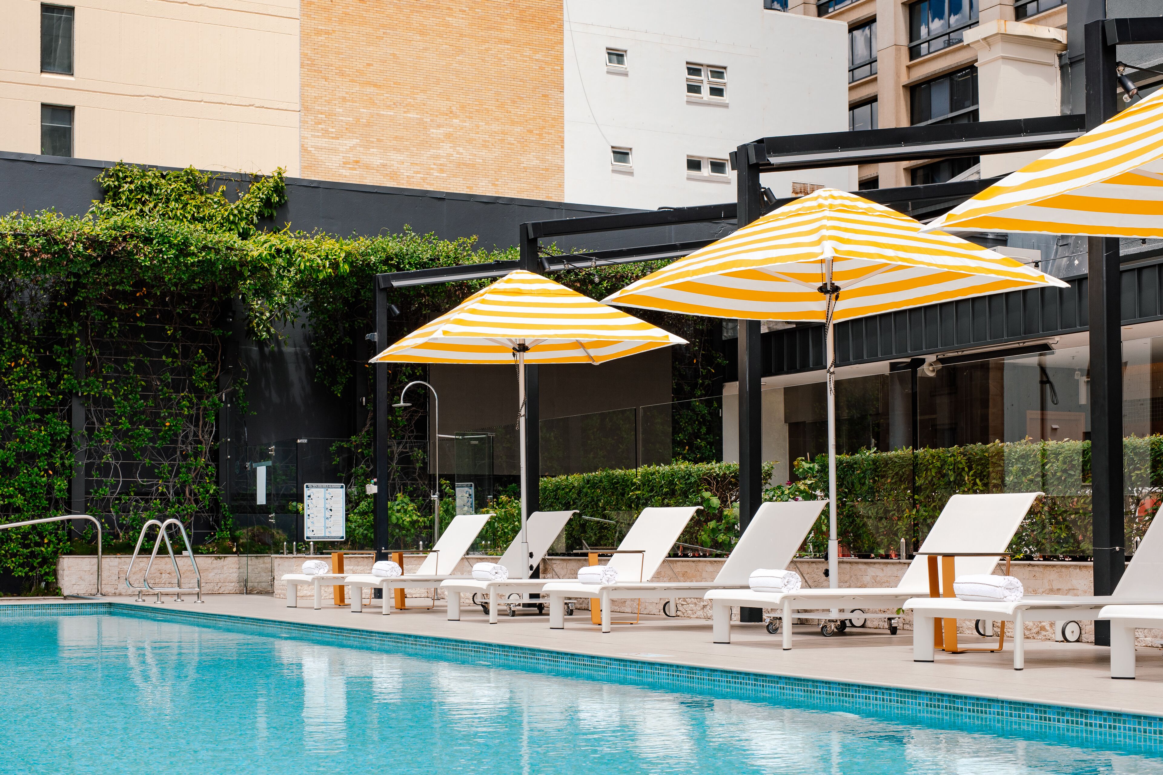 outdoor pool, open 6:00 am to 8:00 pm, pool umbrellas, pool loungers