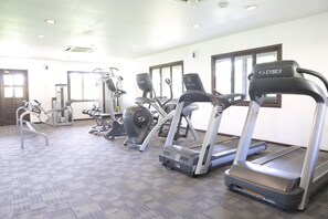 A gym with treadmills, ellipticals, and weight machines.