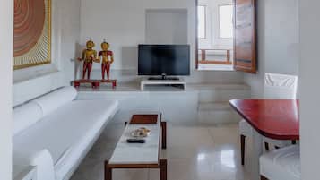 Relax in this stylish living room with a sofa, coffee table, flat-screen TV, and a convenient remote control.