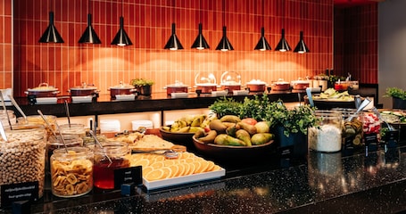 A buffet with various food items and condiments, including fruits, nuts, and honey.. Tallink Express Hotel