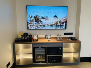 A hotel reception area with a television displaying a tropical resort image and the text "HAVE A WONDERFUL STAY". - Bangi Resort Hotel (Bandar Baru Bangi)