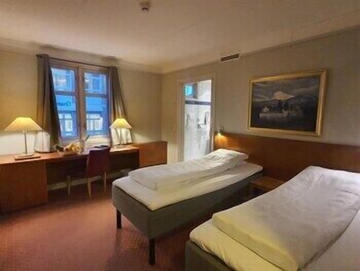 Premium bedding, desk, laptop workspace, blackout drapes