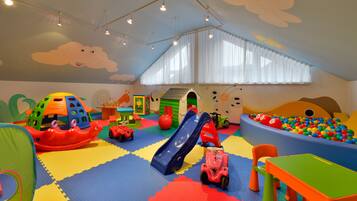 A playroom with colorful toys, a slide, and a ball pit.