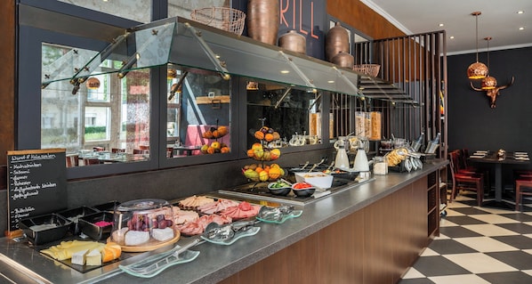 A buffet counter with various food items and a chalkboard menu listing options like 'Kochschinken' and 'Salomi'.