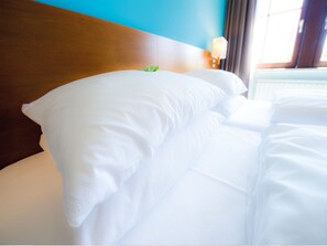 Premium bedding, down comforters, minibar, in-room safe