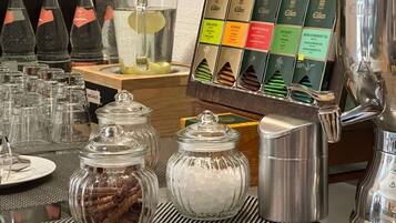 A coffee station with various tea and coffee options, including a selection of teas and a coffee machine.