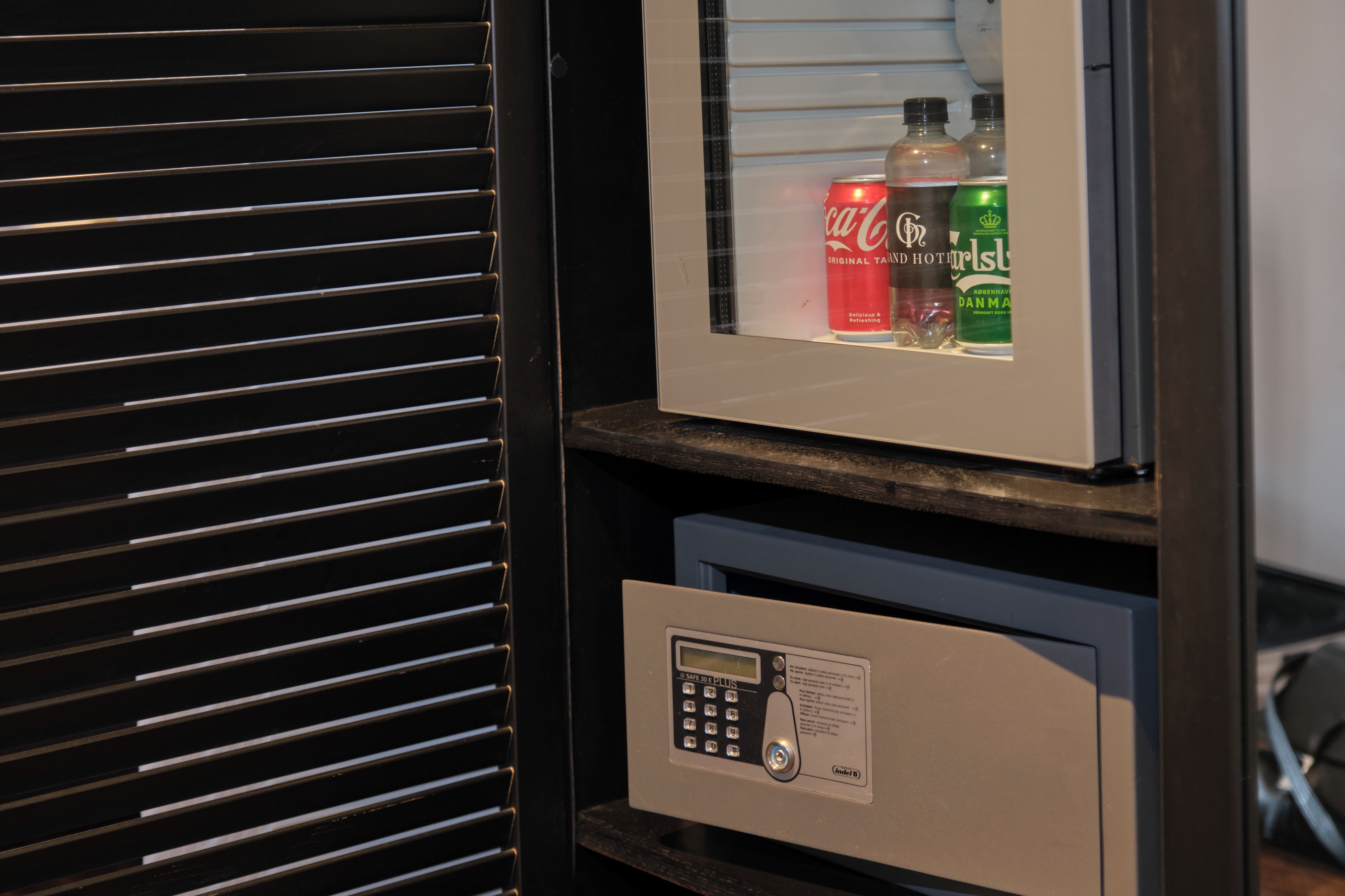 A minibar with beverages and a safe.