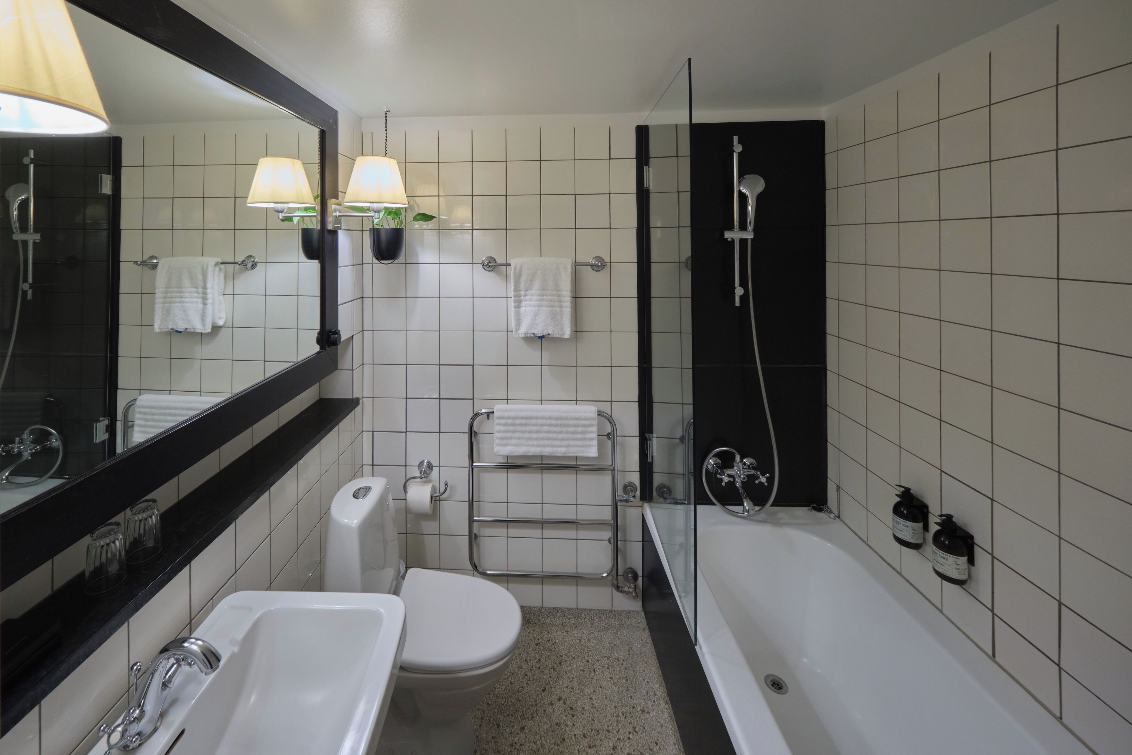 A modern bathroom with a bathtub, a toilet, a sink, and a shower.