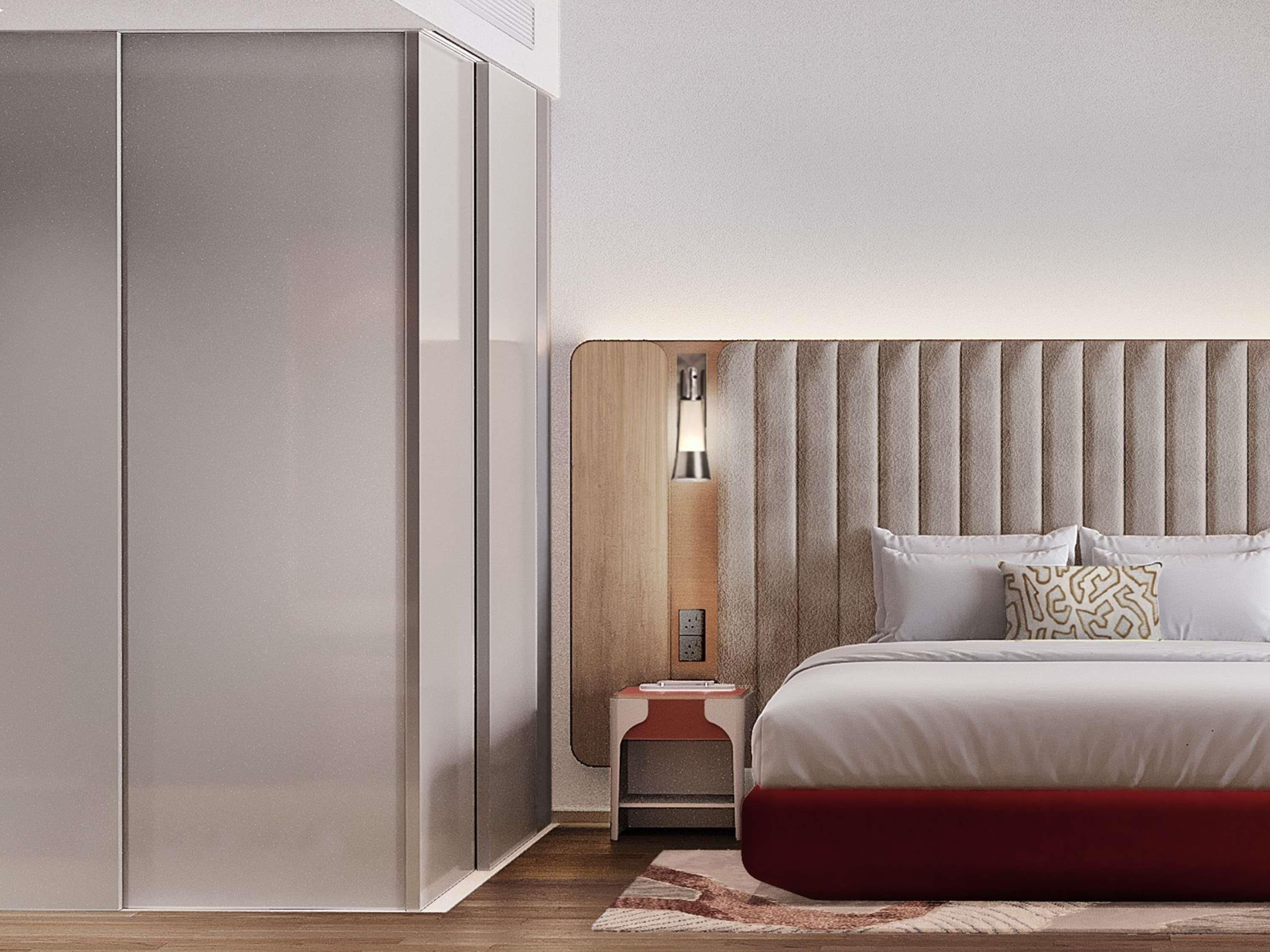 Un dormitorio moderno con cama, mesita de noche y lámpara de pared.