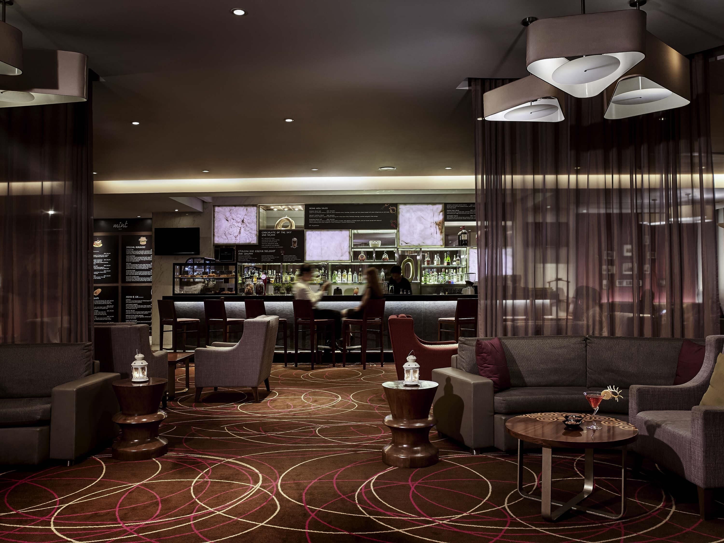 A modern bar area with seating and a bar counter.
