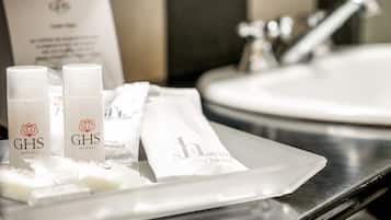 A tray with toiletries and a bar soap at a hotel sink.