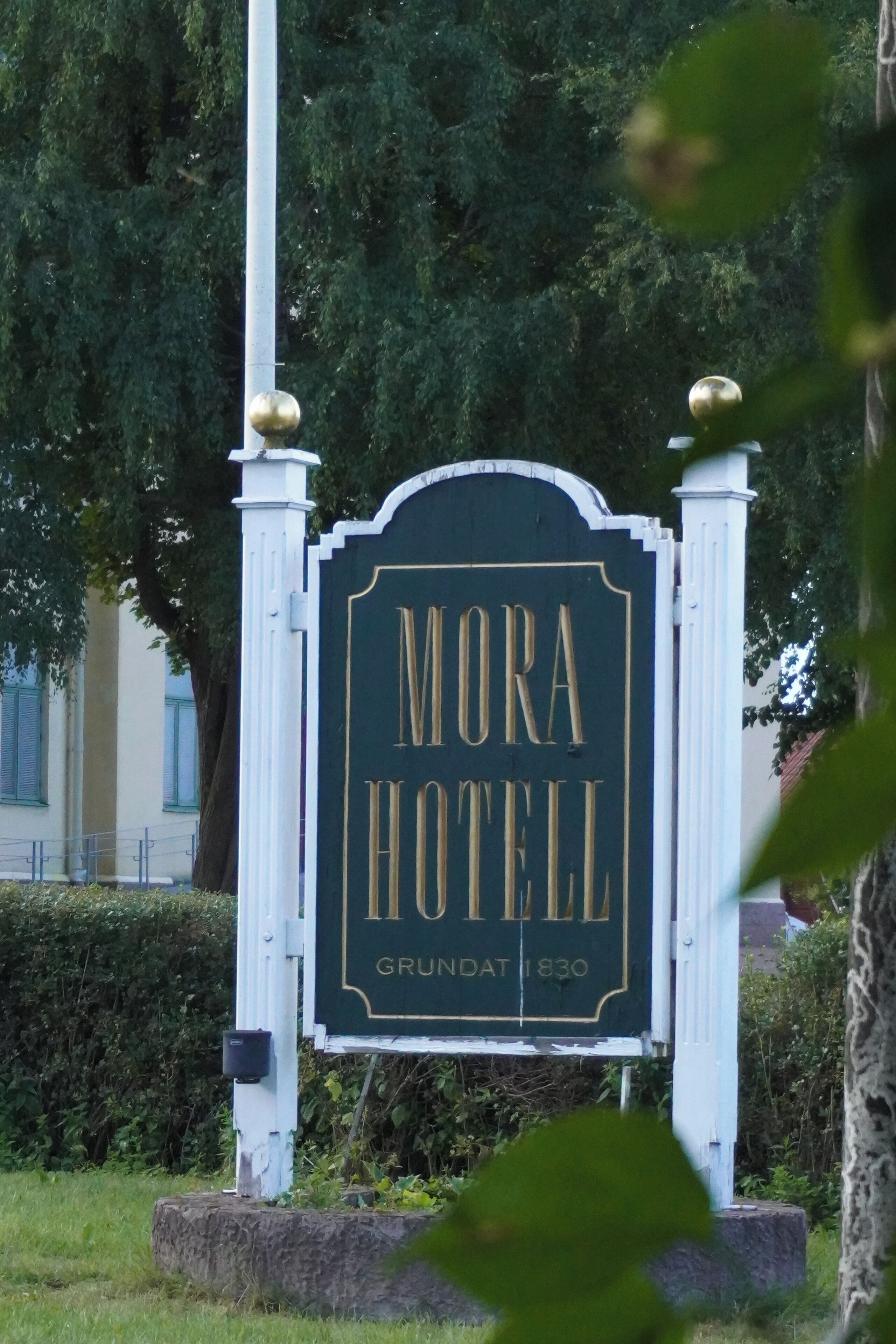A sign for Mora Hotel with the name and establishment year.